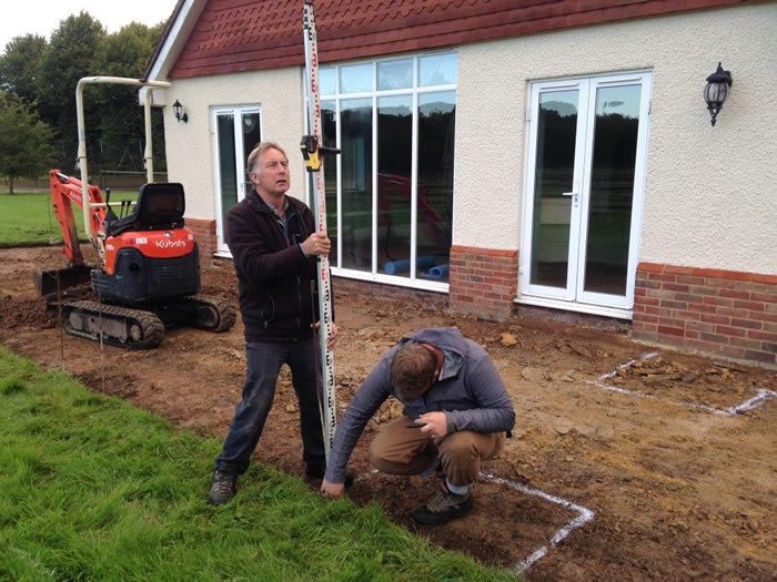 Then the beds and patio areas are marked out as per Alison’s design plan. In this photo, my foreman Andy can be seen making sure the levels are correct by using a staff formation.