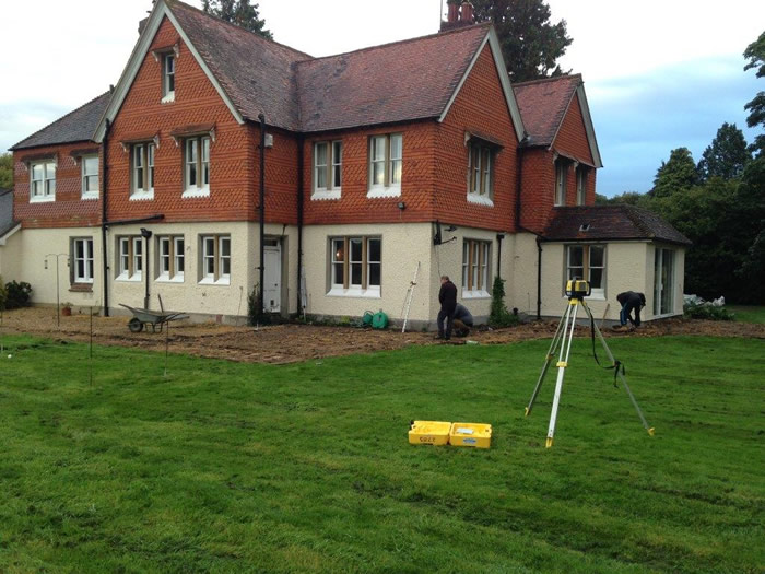 Levels are set (also allowing for an appropriate fall – and direction of fall - for drainage) by using a laser level which sits on a tripod. 