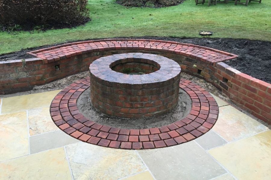 The 3-deep row of brick pavers are now laid around the base of the well.