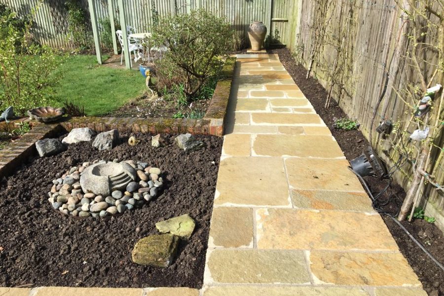 The new limestone pathway leading to the bottom of the garden gives width and impact to this space.